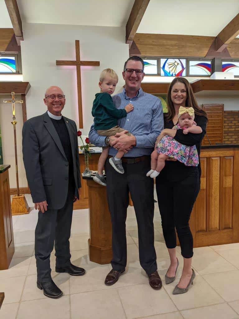 Pastor Magruder, father and mother, brother and baby after her baptism at Peace With Christ Lutheran Church in Fort Collins, CO
