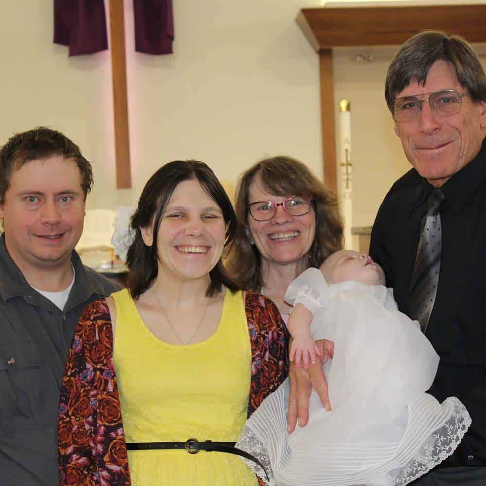 Mother and father, grandmother and grandfather and baby after her baptism at Peace With Christ Lutheran Church in Fort Collins, CO
